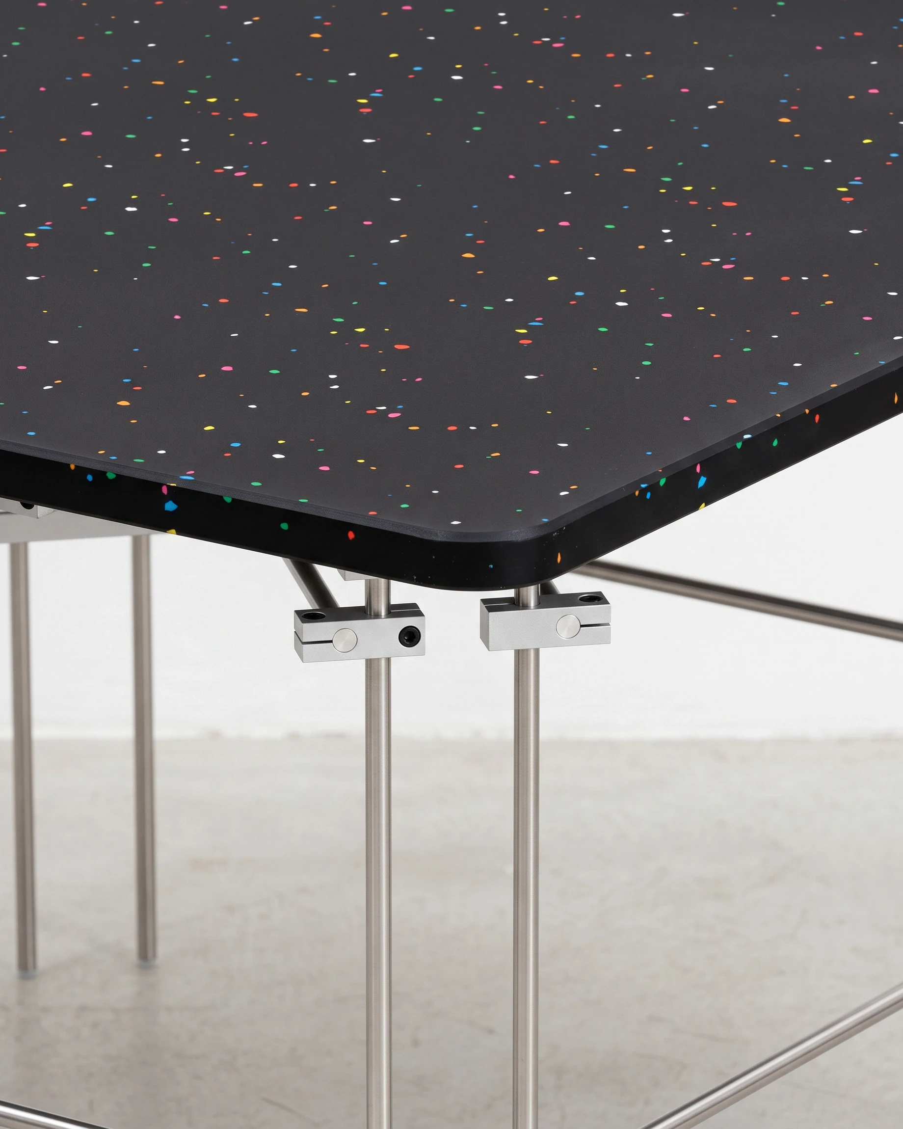 Chess Player, coffee table 80 × 80, black, colour flecks: joint close-up