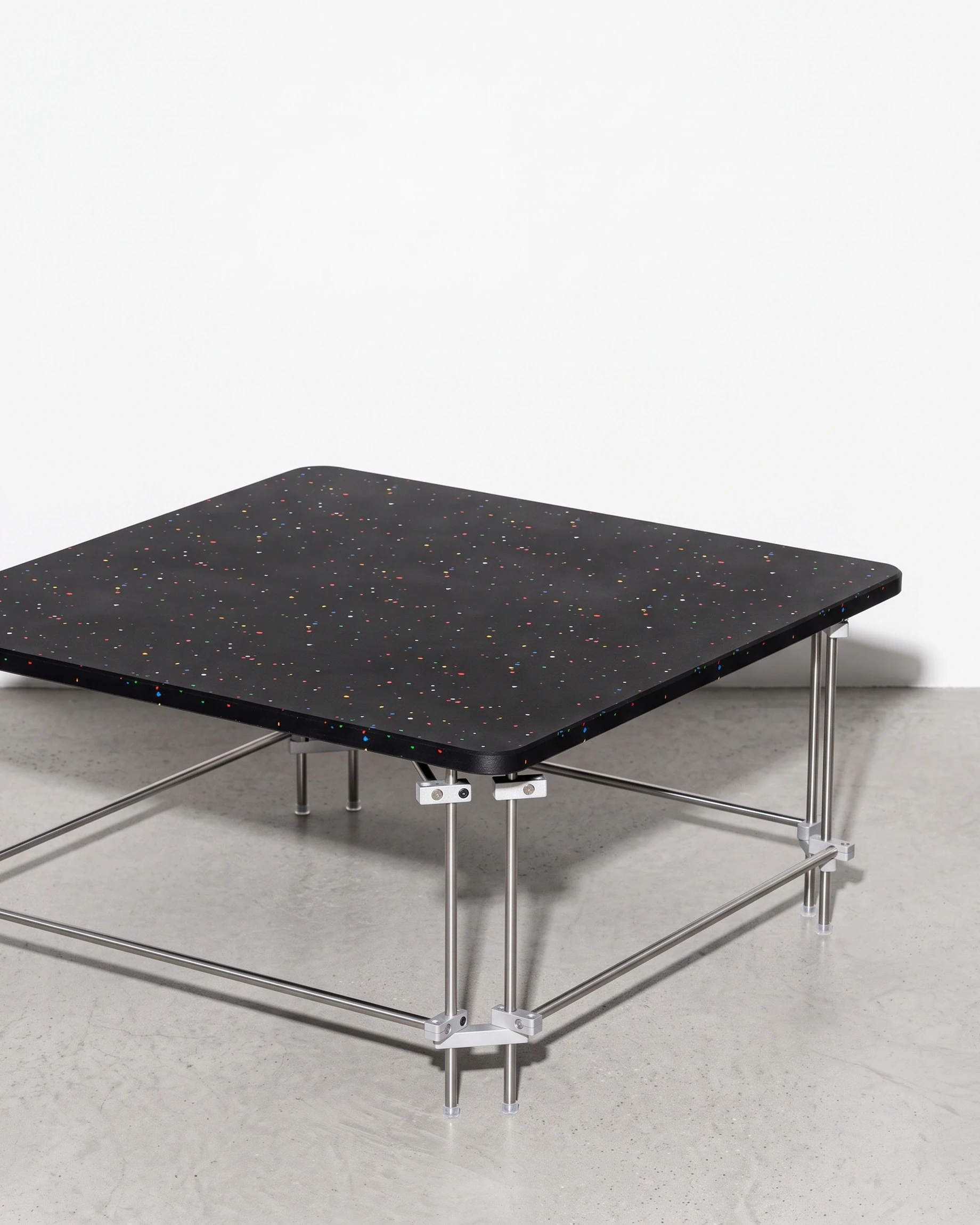 Chess Player, coffee table 80 × 80, black, colour flecks: front right view